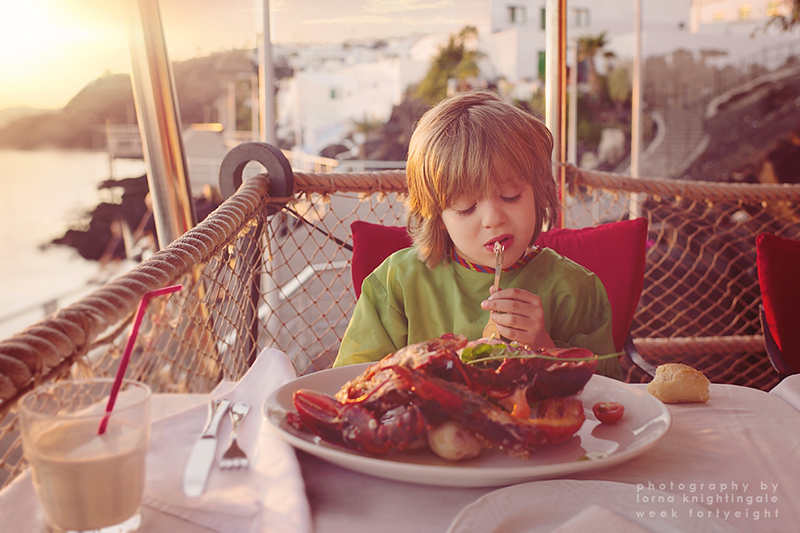 little one eating lobster