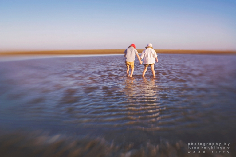 twin-boys-holding-hands-on-a-beach